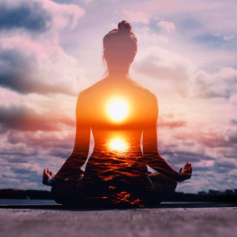 Yoga day concept. Multiple exposure image. Woman practicing lotus asana at sunset.